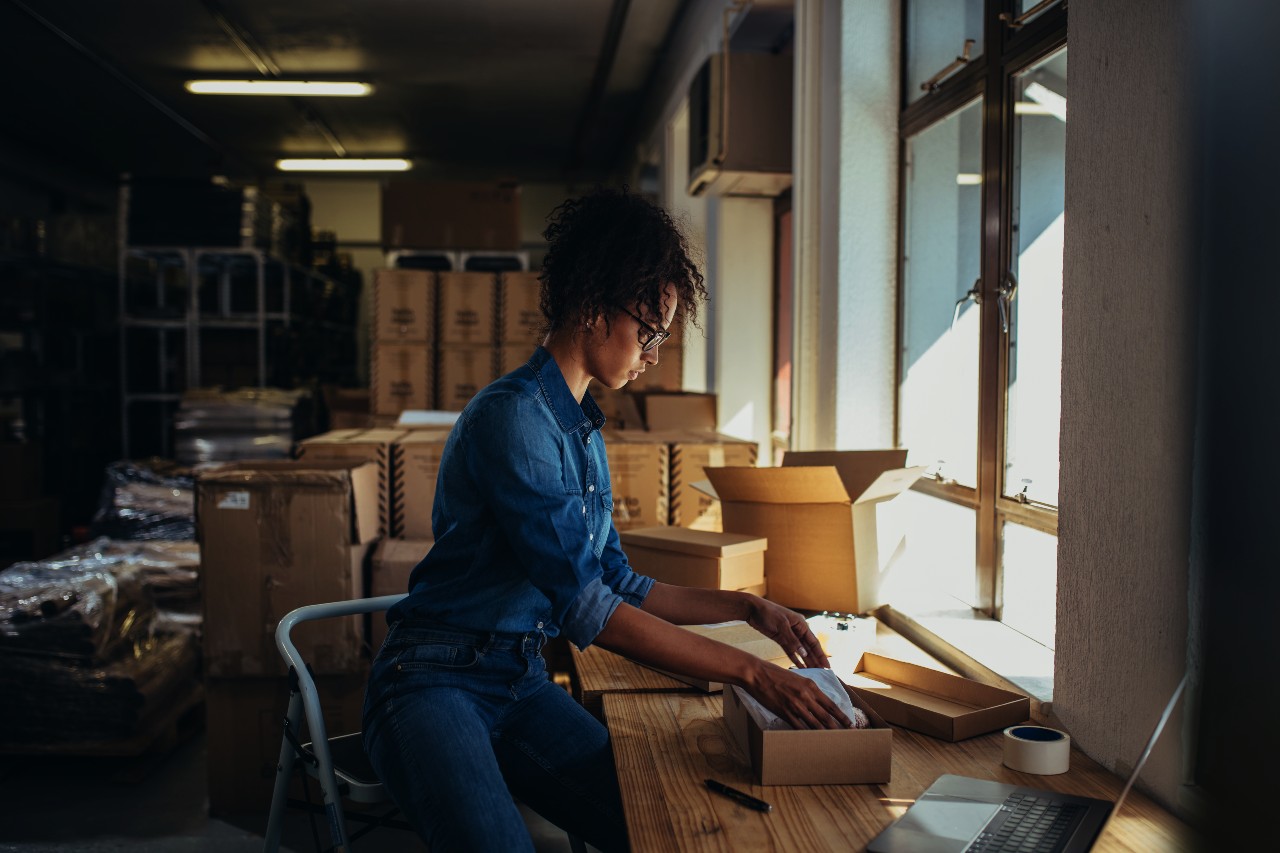 Woman packing an ecommerce order